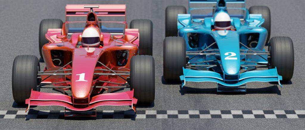 A red race car crossing the finish line.
